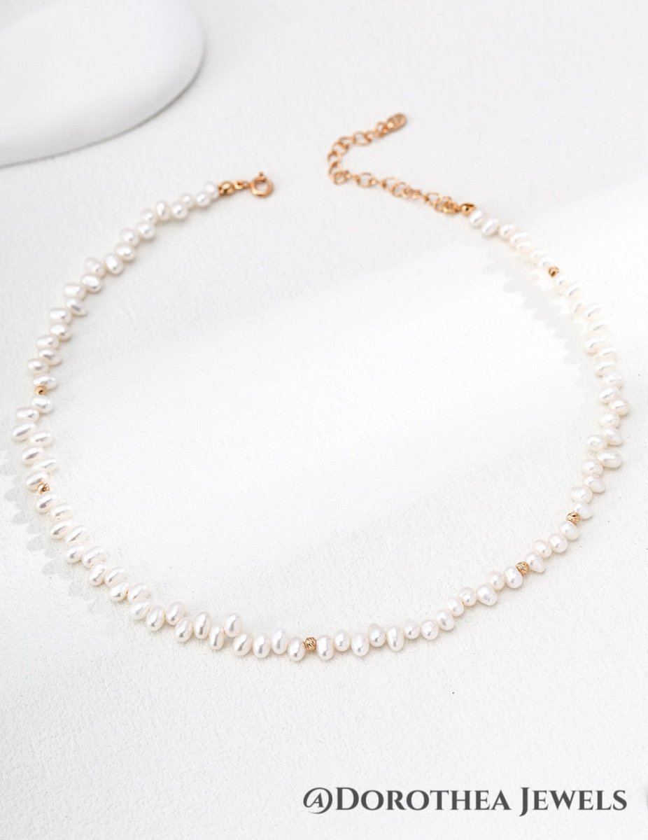Delicate Rice Pearl Station Necklace with Gold Bead Accents - DOROTHEA JEWELS