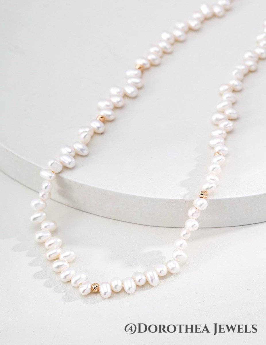 Delicate Rice Pearl Station Necklace with Gold Bead Accents - DOROTHEA JEWELS